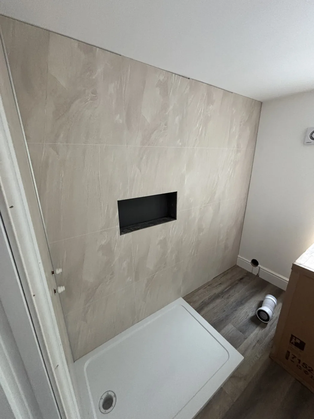 Completed bathroom with shower tray and wall panels